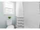Bright bathroom features a shower/tub combination with a striped shower curtain at 101 Vista Brooke Dr, Morrisville, NC 27560