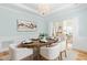Inviting dining area with designer lighting, pale blue walls, and dining for six people at 101 Vista Brooke Dr, Morrisville, NC 27560