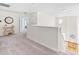 Upstairs hallway features neutral carpet, white walls, decorative clock, and staircase at 101 Vista Brooke Dr, Morrisville, NC 27560