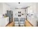 Bright kitchen with white cabinetry, stainless appliances, center island, and wood floors at 101 Vista Brooke Dr, Morrisville, NC 27560
