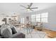 Cozy living room features hardwood floors, a ceiling fan, and plenty of natural light at 101 Vista Brooke Dr, Morrisville, NC 27560