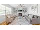 Comfortable living room boasts built-in shelving, fireplace, a ceiling fan, and a neutral color palette at 101 Vista Brooke Dr, Morrisville, NC 27560
