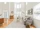 Bright living room with soaring ceilings, large windows, hardwood floors, and a cozy seating area with stylish decor at 101 Vista Brooke Dr, Morrisville, NC 27560