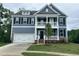 Charming two-story home featuring a welcoming porch and a well-manicured lawn at 103 Berry Mill Ln # 133, Raleigh, NC 27603