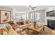 Cozy living room features a fireplace and adjoins to the kitchen, breakfast, and sunroom at 103 Berry Mill Ln # 133, Raleigh, NC 27603