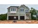Two-story home features a two-car garage, light green siding and white trim at 107 Berry Mill Ln # 134, Raleigh, NC 27603