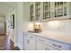 Stylish bar area with glass-front cabinets and white subway tile backsplash at 108 Berry Mill Ln # 132, Raleigh, NC 27603