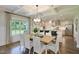 Elegant dining room with coffered ceiling, large window, and view of the kitchen at 108 Berry Mill Ln # 132, Raleigh, NC 27603