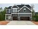 Charming two-story home featuring a modern gray exterior with stone accents and a spacious two-car garage at 108 Berry Mill Ln # 132, Raleigh, NC 27603