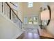 Spacious foyer with hardwood floors, staircase, and view of the front door at 108 Berry Mill Ln # 132, Raleigh, NC 27603