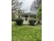 Charming single-story home with a cozy front porch surrounded by lush greenery and mature trees at 108 Virgil Rd, Durham, NC 27703