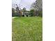 Quaint single-story home with a covered porch surrounded by a lush, green lawn and mature trees at 108 Virgil Rd, Durham, NC 27703