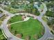 Aerial view of the neighborhood featuring a circular park, lake, and surrounding homes at 111 Finnway Ln, Cary, NC 27519