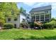 Expansive backyard featuring a screened in porch, tiered patio, and lush lawn at 111 Finnway Ln, Cary, NC 27519