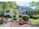 Charming backyard featuring a cozy seating area, lush greenery, and the home's exterior at 111 Finnway Ln, Cary, NC 27519