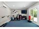 Finished basement gym area with a stationary bike, weights, and a sliding glass door for natural light at 111 Finnway Ln, Cary, NC 27519