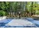 Outdoor basketball court for recreation and sports, set amongst trees and manicured hedges at 111 Finnway Ln, Cary, NC 27519