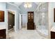 Bright primary bathroom with marble floors, cabinets, walk-in shower, and private toilet room at 111 Finnway Ln, Cary, NC 27519