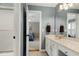 Bathroom featuring a white vanity, large mirror, and views of the bedroom and shower area at 111 Finnway Ln, Cary, NC 27519