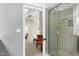 Bright bathroom featuring a glass shower with gray tiling and a view into the bedroom with sitting area at 111 Finnway Ln, Cary, NC 27519