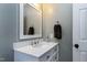 Bathroom featuring white vanity with quartz counters, chrome faucet, and a mirror with built-in lights at 111 Finnway Ln, Cary, NC 27519