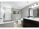 Bathroom with dark vanity, modern fixtures, and natural light creating a clean and functional space at 111 Finnway Ln, Cary, NC 27519