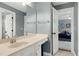 Bathroom with white vanity, large mirror, and doorway leading to the bedroom, enhancing the home's appeal at 111 Finnway Ln, Cary, NC 27519