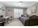 Bedroom with surf decor, a large window, and a bed with grey covers at 111 Finnway Ln, Cary, NC 27519