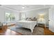 Bright bedroom with tray ceiling, hardwood floors, and large windows at 111 Finnway Ln, Cary, NC 27519