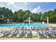 Large community pool surrounded by lounge chairs and lush greenery at 111 Finnway Ln, Cary, NC 27519