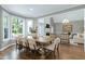 Open dining area with large windows offers seamless flow into the living room with fireplace at 111 Finnway Ln, Cary, NC 27519
