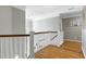 Upstairs hallway with hardwood floors and natural light at 111 Finnway Ln, Cary, NC 27519