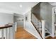 Hallway with hardwood floors and white staircase at 111 Finnway Ln, Cary, NC 27519
