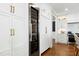 Modern kitchen with built-in wine storage, stainless appliances, and custom cabinets at 111 Finnway Ln, Cary, NC 27519
