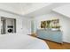 Bright main bedroom featuring a tray ceiling, hardwood floors, and en suite bathroom at 111 Finnway Ln, Cary, NC 27519