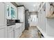 Mud room featuring built-in shelving, a utility sink, and stacked washer and dryer at 111 Finnway Ln, Cary, NC 27519