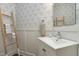 Chic powder room featuring elegant wallpaper, modern fixtures, and decorative accents at 111 Finnway Ln, Cary, NC 27519