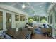 Inviting screened porch with vaulted ceiling, ceiling fans, and dining and living areas at 111 Finnway Ln, Cary, NC 27519