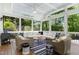 Relaxing sunroom filled with natural light and comfortable seating, surrounded by lush greenery at 111 Finnway Ln, Cary, NC 27519