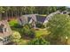 Aerial view of the home showcasing the property, mature trees, and manicured lawn at 1141 Contender Dr, Clayton, NC 27520