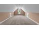 Spacious finished attic featuring neutral walls, carpet, and natural light from an arched window at 1141 Contender Dr, Clayton, NC 27520