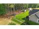 Large backyard with mature trees, trampoline, and storage sheds on the property at 1141 Contender Dr, Clayton, NC 27520