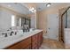 Bathroom with double vanity, tile floor, and walk-in shower with glass door at 1141 Contender Dr, Clayton, NC 27520