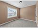Bedroom features neutral paint, carpet, window and closet at 1141 Contender Dr, Clayton, NC 27520