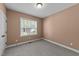 Cozy bedroom featuring neutral carpet and walls complemented by a bright window for natural light at 1141 Contender Dr, Clayton, NC 27520
