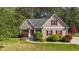 Charming home boasts a well-maintained lawn, mature trees, and vibrant landscaping at 1141 Contender Dr, Clayton, NC 27520