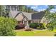 Attractive home with a well manicured front yard, lush plantings, and bright red shutters at 1141 Contender Dr, Clayton, NC 27520