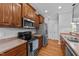 Kitchen with stainless steel appliances, wooden cabinets, and a tile backsplash at 1141 Contender Dr, Clayton, NC 27520