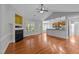 An open-concept living room with wood floors, fireplace, and breakfast bar to the kitchen at 1141 Contender Dr, Clayton, NC 27520