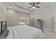 Carpeted bedroom with neutral walls, window, tray ceiling, and ceiling fan at 1141 Contender Dr, Clayton, NC 27520